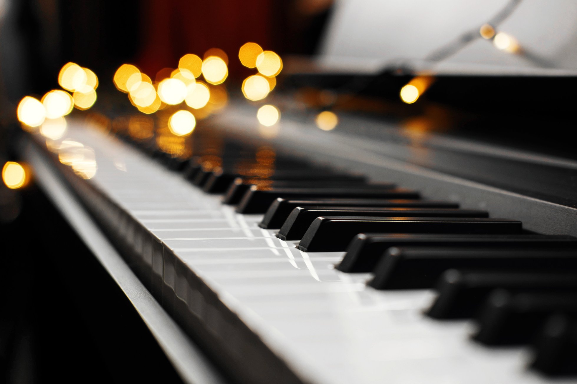 piano keys bokeh in the background Christmas lights